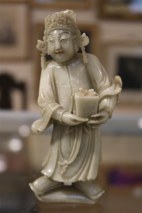 A Chinese soapstone carving of a man holding a jardiniere & other carvings
